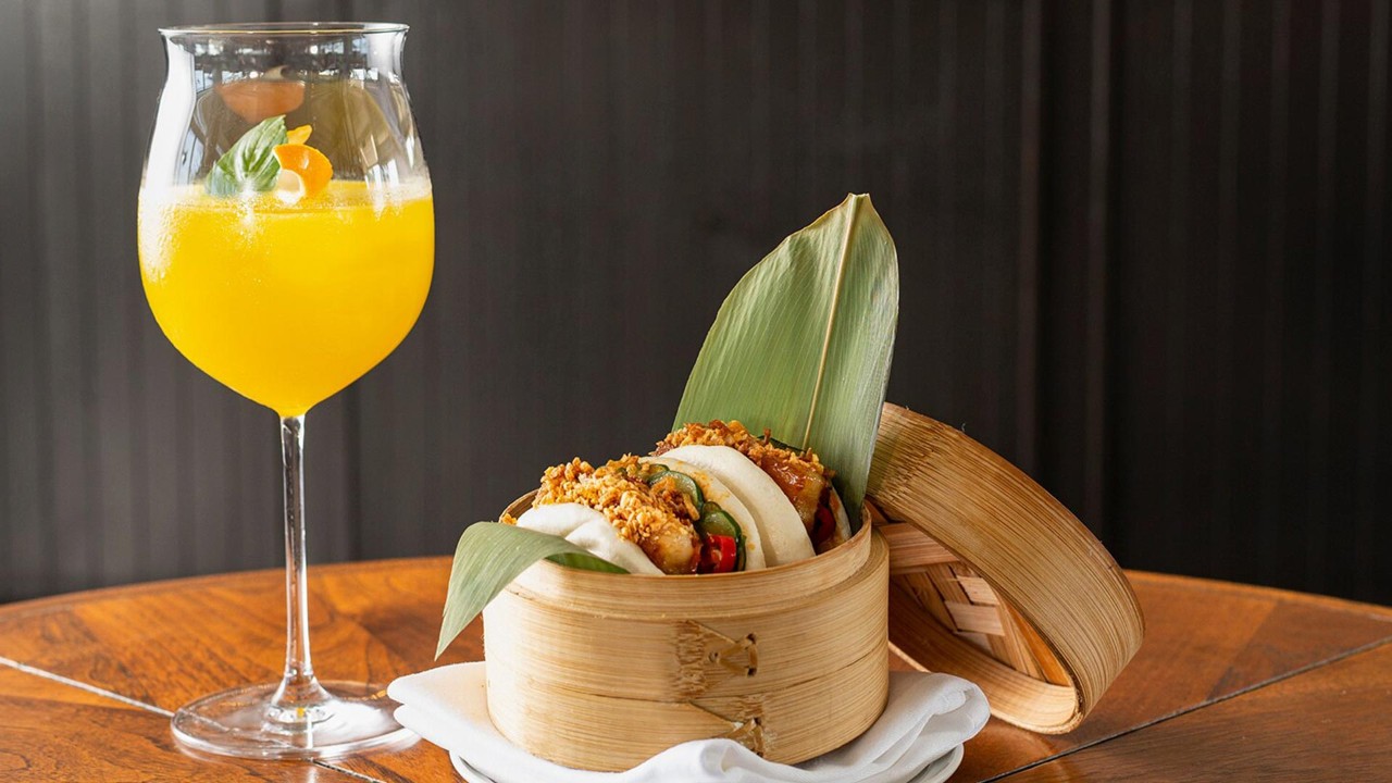 Cocktail and pork bun at Spago for dinner and drinks after visiting hidden photo spots in Singapore