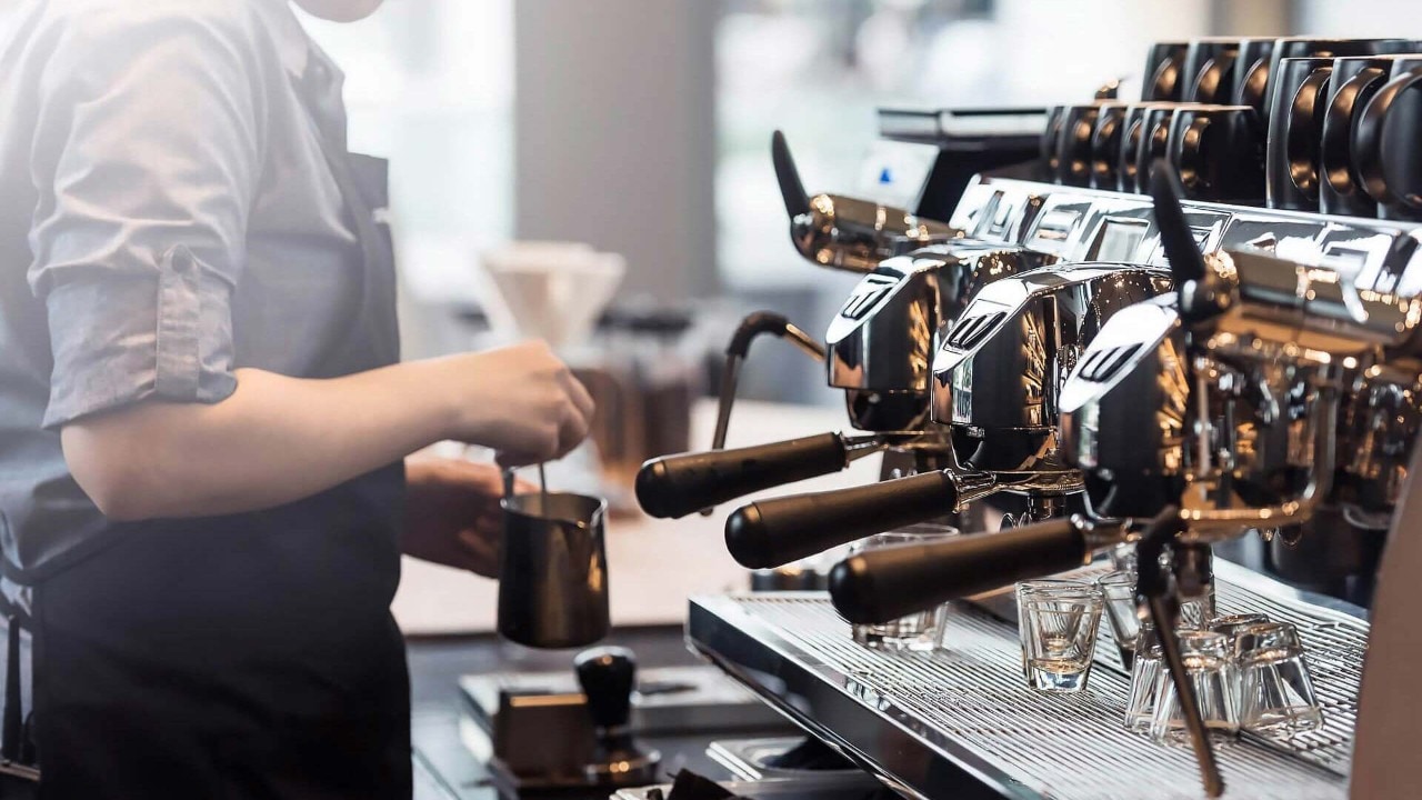 Barista at Starbucks, a popular coffee cafe in Singapore, using the espresso machine