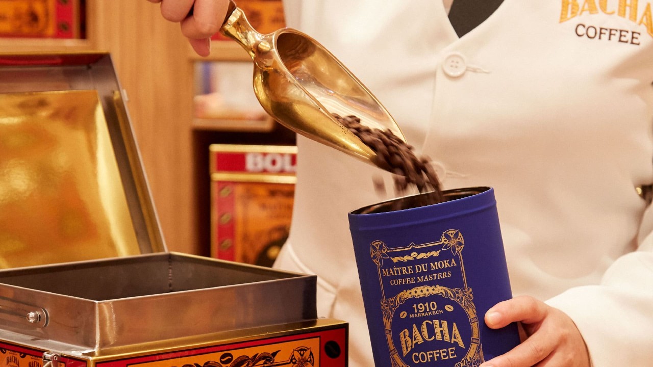 Man pouring coffee beans at Bacha Coffee, the best dessert shops and cafes in Singapore