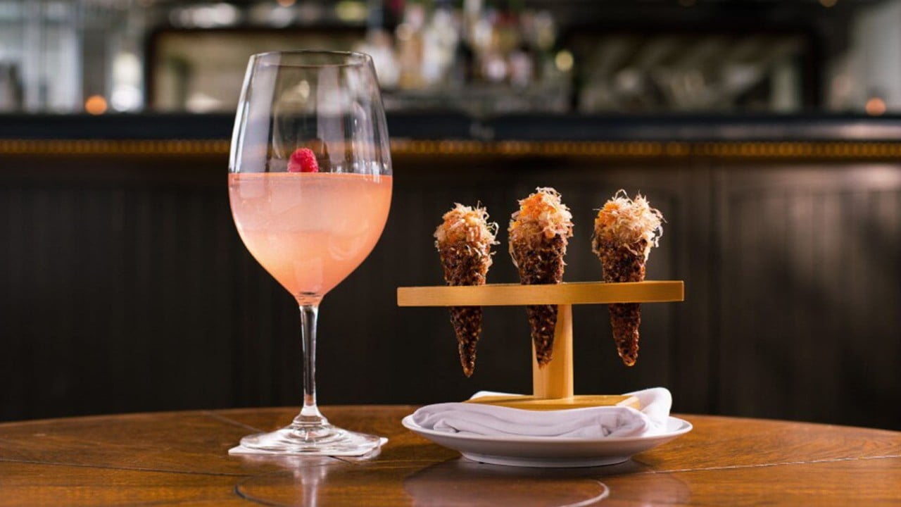 A pink cocktail with three tartare cones served at an instagrammable restaurant, Spago Dining Room